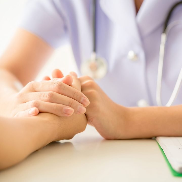 female psychologist consulting patient at the desk in hospital. Medicine and health care concept
